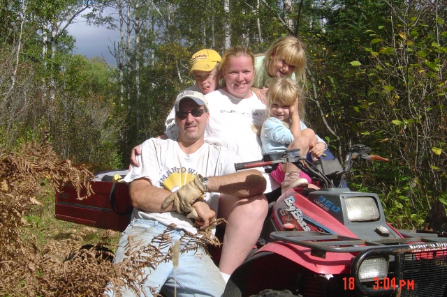 Ballavance family, at the cabin, gathering wood for a sauna.